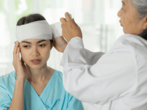 Young woman receiving medical care for a head injury
