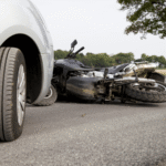 Motorcycle lying on the road after a collision with a car