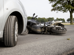 Motorcycle lying on the road after a collision with a car